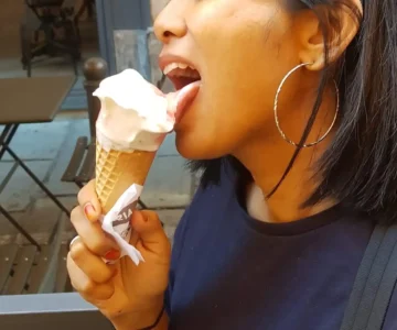 A woman expressing sensuality while licking ice cream