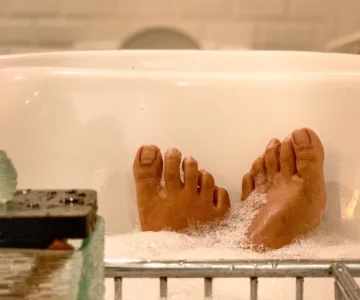 Feet popping out of a bubble bath, highlighting unexpected erogenous zones