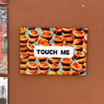 An artwork with the words "touch me"
